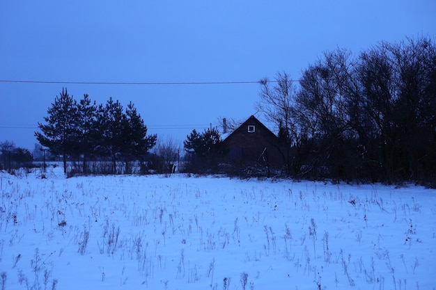 a house in a field with a house in the background