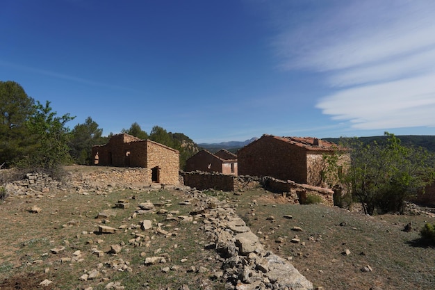 A house in a field with a mountain in the background