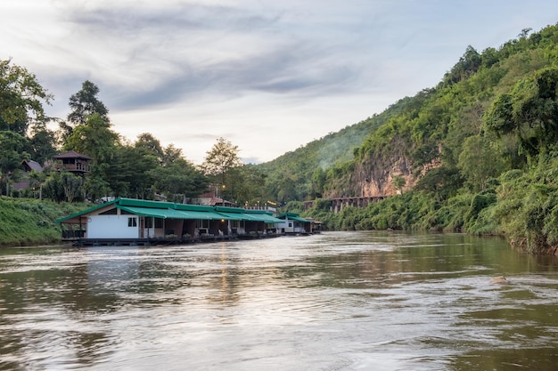 House floating on river kwai with ancient wooden railway