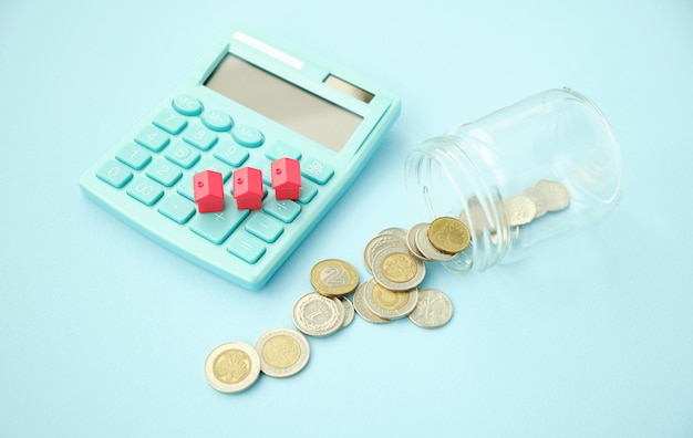 House, gold coins and calculator for mortgage loan conceptual