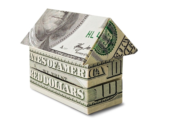 The house is stacked of dollar bills on a white isolated background Element for design Buying and selling housing Mortgage Property rental Closeup Money Business