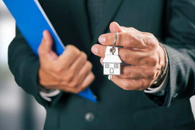 House key in businessman hand