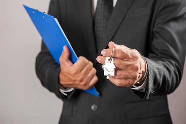 House key in businessman hand