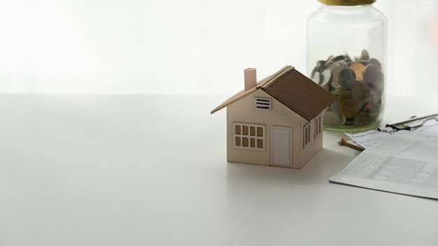 House model and paperwork on a white desk