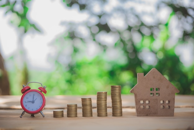 House placed on coins Men's hand is planning savings money of coins