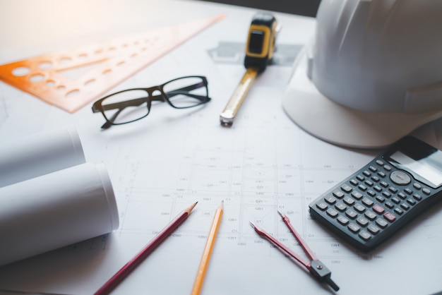 House plan on a work desk with work equipment