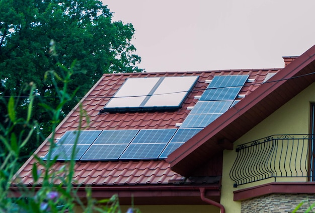 House roof with photovoltaic modules. Historic farm house with modern solar panels on roof and wall