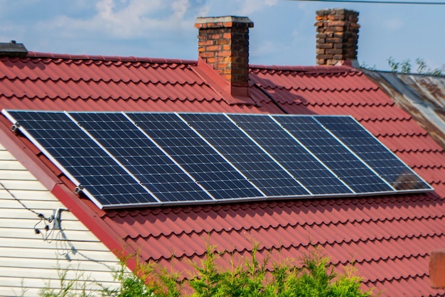 House roof with photovoltaic modules. Historic farm house with modern solar panels on roof and wall