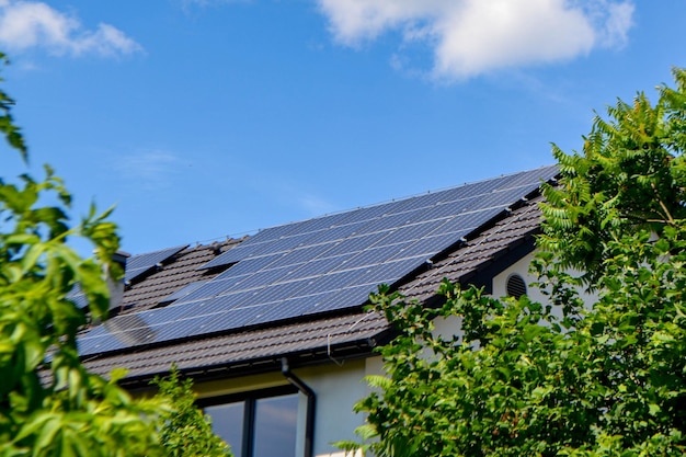 House roof with photovoltaic modules. Historic farm house with modern solar panels on roof and wall