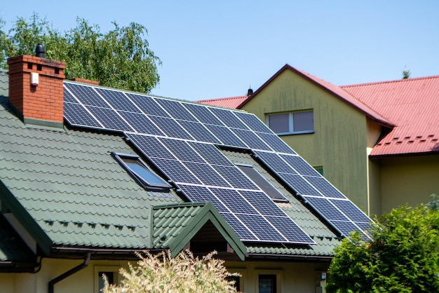 House roof with photovoltaic modules. Historic farm house with modern solar panels on roof and wall