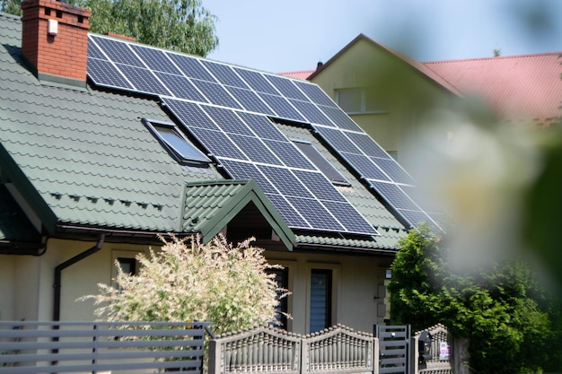 House roof with photovoltaic modules. Historic farm house with modern solar panels on roof and wall