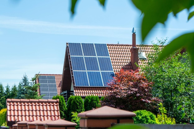 House roof with photovoltaic modules. Historic farm house with modern solar panels on roof and wall