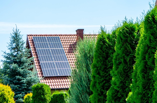 House roof with photovoltaic modules. Historic farm house with modern solar panels on roof and wall