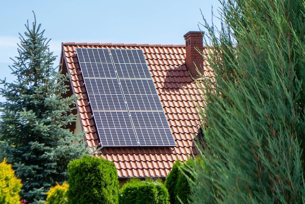 House roof with photovoltaic modules. Historic farm house with modern solar panels on roof and wall