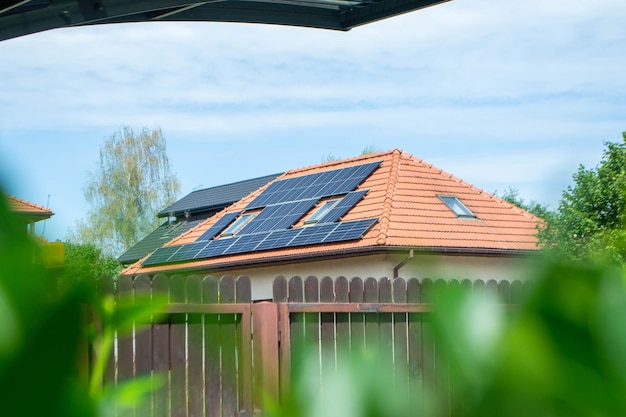 House roof with photovoltaic modules. Historic farm house with modern solar panels on roof and wall