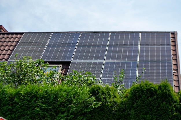 House roof with photovoltaic modules. Historic farm house with modern solar panels on roof and wall