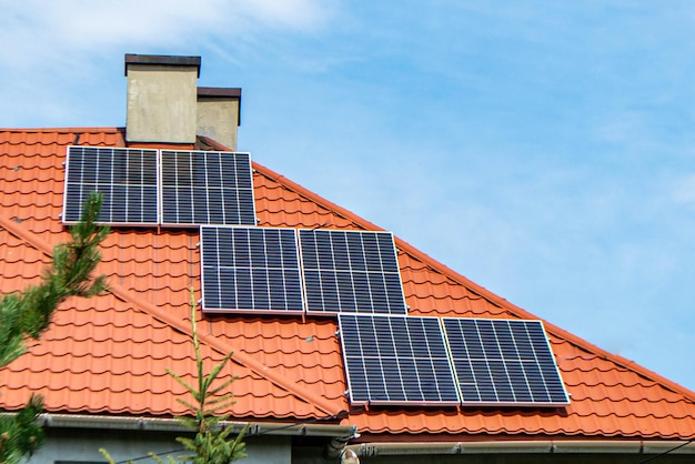 House roof with photovoltaic modules. Historic farm house with modern solar panels on roof and wall