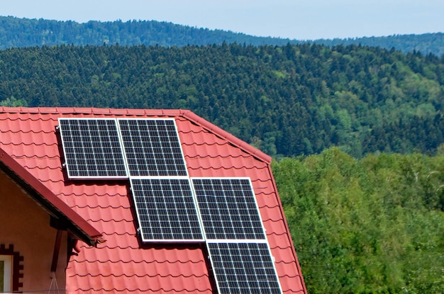 House roof with photovoltaic modules. Historic farm house with modern solar panels on roof and wall