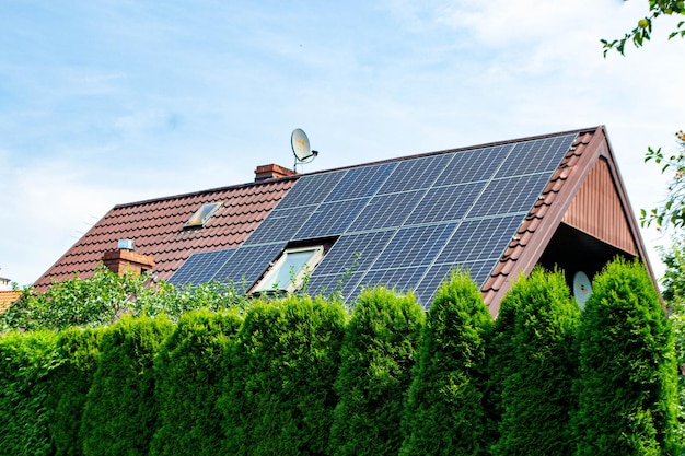 House roof with photovoltaic modules. Historic farm house with modern solar panels on roof and wall