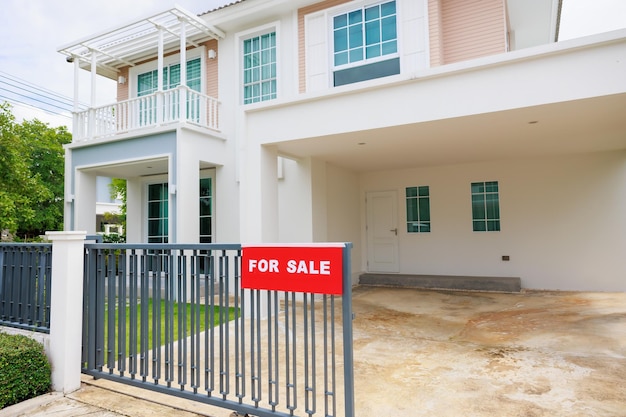 House For Sale Real Estate Sign in Front of Beautiful New House Promp for buyer findding