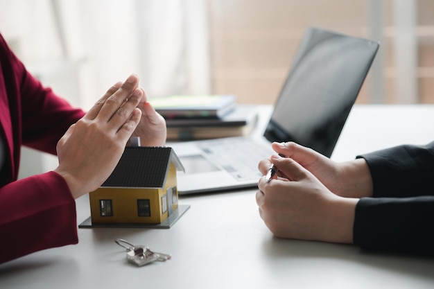 Photo house sales representatives sales representatives recommend housing details in the project to customers who are interested in viewing the houses in the project real estate trading concept