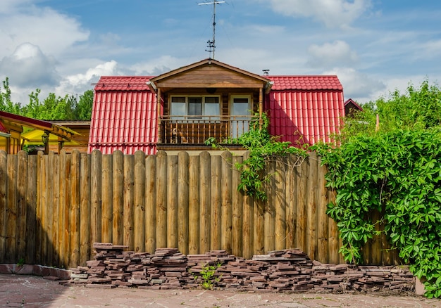 A house in the village behind a wooden fence.