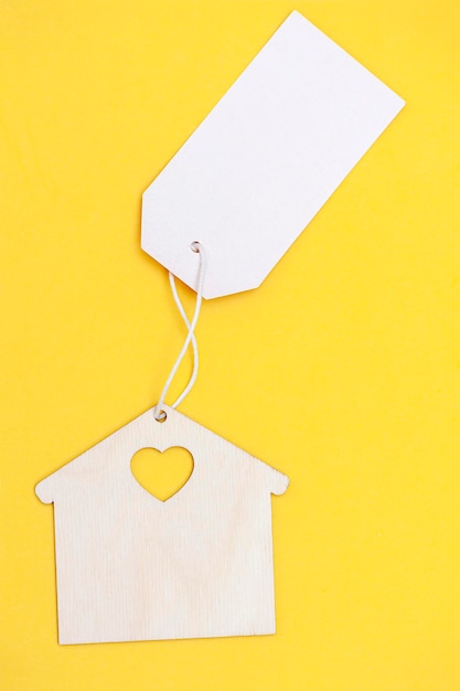 House with a blank sign on a yellow background Vertical photo