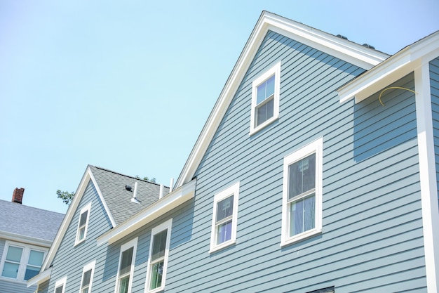 A house with a blue roof and a blue sky background