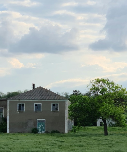 A house with a green door is in the grass.