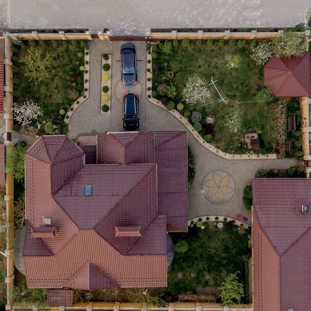 House with a paved yard with green grass lawn