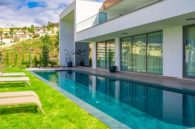 A house with a pool and a house in the background