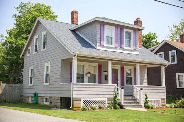 A house with purple trim and a porch with a porch.