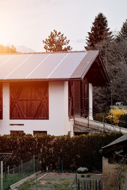 House with solar panels on the roof Natureproduced energy Sunproduced energy Photovoltaic syste