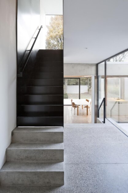 a house with a staircase and a staircase that has a glass door that leads to a balcony