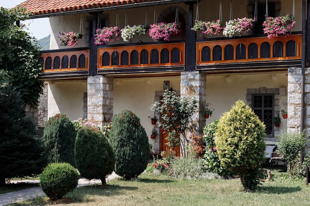 House with tiled roof in a flowering garden in summer