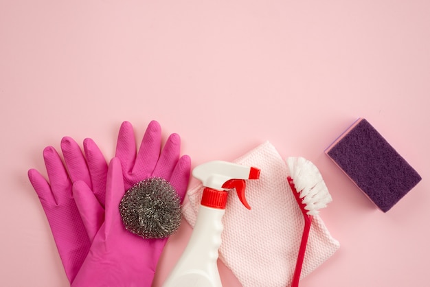 Household brush, kitchen sponge, cleaning spray and rag lying