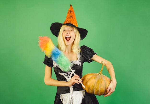 Housekeeper with Pumpkin and knife. Costumes housekeeper and Halloween hats.