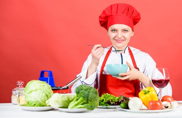 Housewife routine Cooking healthy food Cooking meal Professional cooking tips Woman chef try taste eat food Delicious recipe concept Girl at kitchen table Cooking food and housekeeping