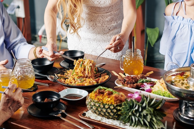 Housewife serving food at dinner