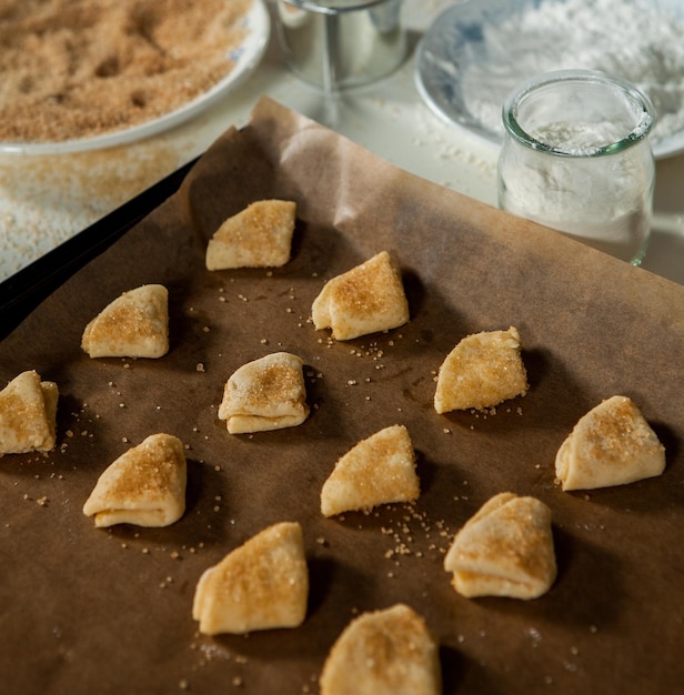 Housewife woman prepares homemade biscuits in the kitchen