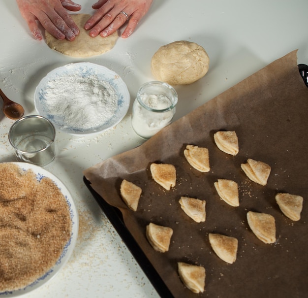 Housewife woman prepares homemade biscuits in the kitchen