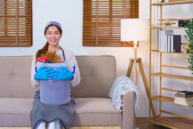 Housework concept Housemaid is wear glove and hold cleaning supplies to prepare cleanups the house