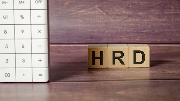 Hrd word written on a wooden block in the background