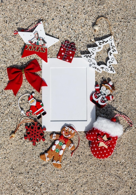 Hristmas composition with mock up on sand background Flat lay top view christmas card