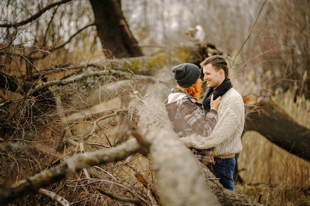 Hug in the autumn park under a tree