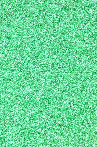 A huge amount of green decorative sequins. image with shiny bokeh lights from small elements