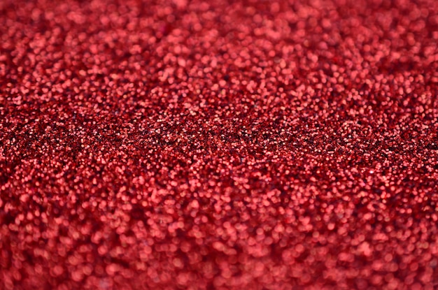 A huge amount of red decorative sequins. Background texture 