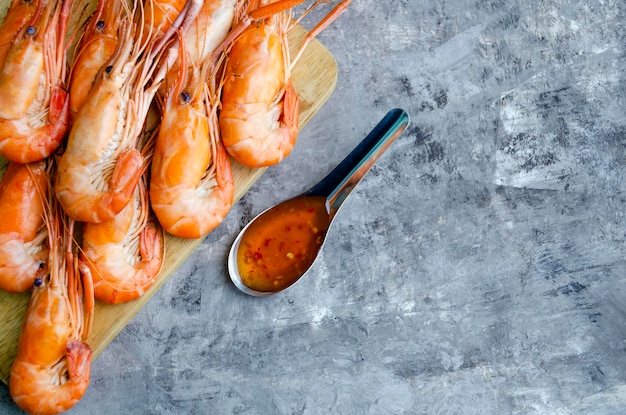 Huge boiled delicious king shrimps on a gray background closeup copy space flat lay