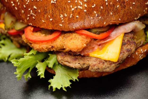 Huge burger on a black background