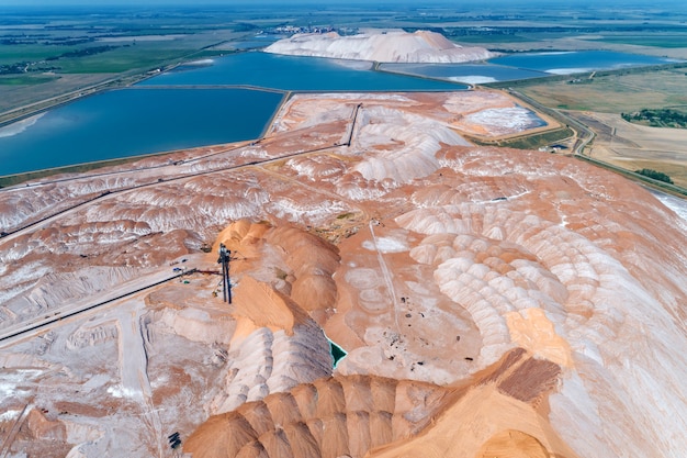 A huge mound of potassium salt. Warehousing of rocks with the help of a spreader